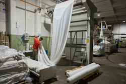 German Flores measures fabric at the Galfione Group textile factory in Buenos Aires, Argentina, Monday, Oct. 13, 2025.