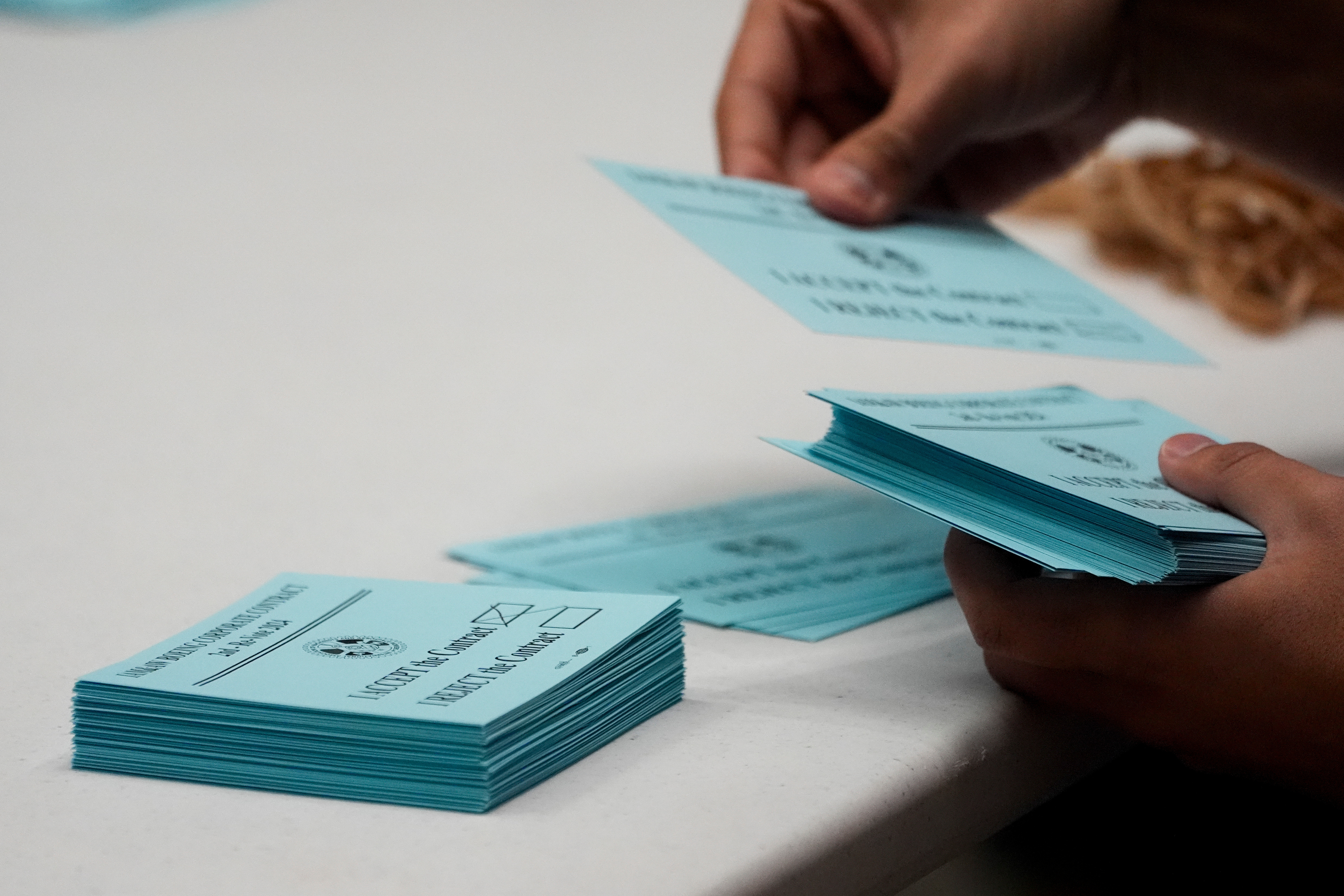 A volunteer sorts votes on a new contract offer from Boeing, Nov. 4, 2024, at the IAM District 751 Union Hall in Seattle.