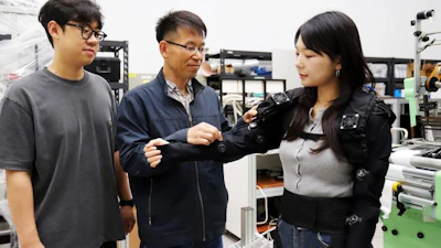 Dr. Cheol Hoon Park(center), principal researcher at KIMM, examines a lightweight clothing-type wearable robot.