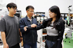 Dr. Cheol Hoon Park(center), principal researcher at KIMM, examines a lightweight clothing-type wearable robot.