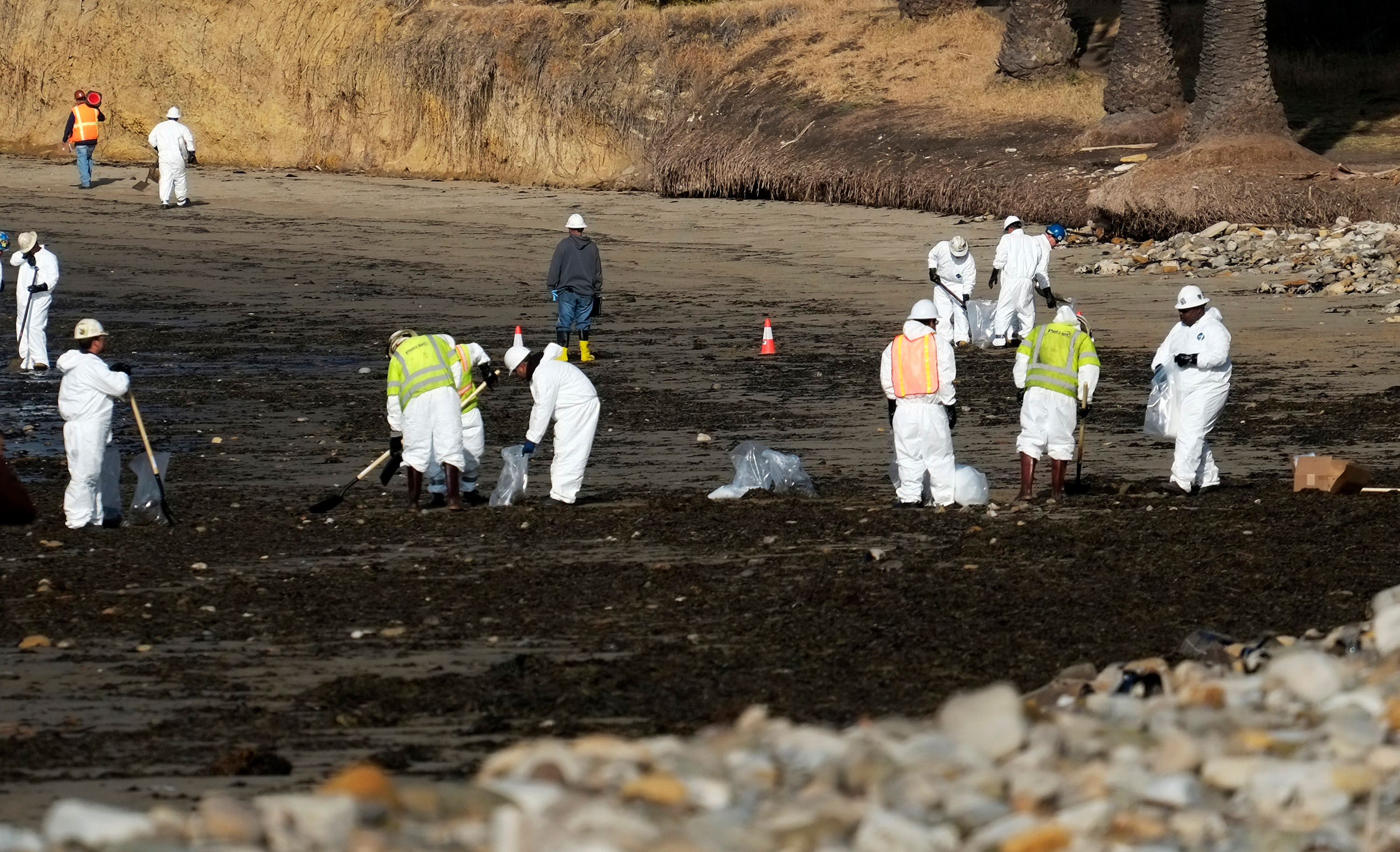 Clean up crews remove oil-laden sand on the beach at Refugio State Beach, site of an oil spill, north of Goleta, Calif., May 20, 2015.