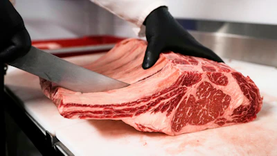 Raul Rubero, lead butcher at Deep Cuts butcher shop cuts single portions of bone-in steaks as he breaks down a side of beef, Wednesday, Aug. 27, 2025, in Dallas.