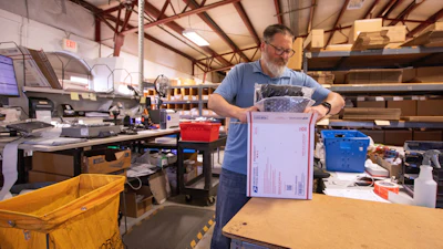 Terry Precision Cycling warehouse manager Luke Tremble packs orders at the company’s warehouse in Burlington, Vt., Oct. 28, 2025.