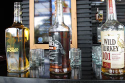 In this Aug. 22, 2014, file photo, Wild Turkey sampling bottles sit on the bar at the distillery's visitors' center near Lawrenceburg, Ky.