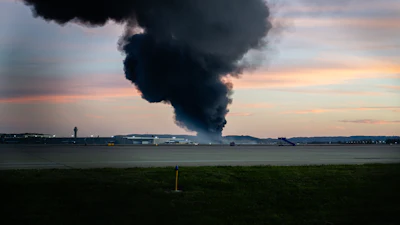 A plume of smoke rises from the site of a UPS cargo plane crash at Louisville Muhammad Ali International Airport on Tuesday, Nov. 4, 2025, in Louisville, Ky.