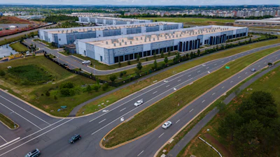 Cars drive past data centers that house computer servers and hardware required to support modern internet use, such as artificial intelligence, in Ashburn, Virginia, July 16, 2023.