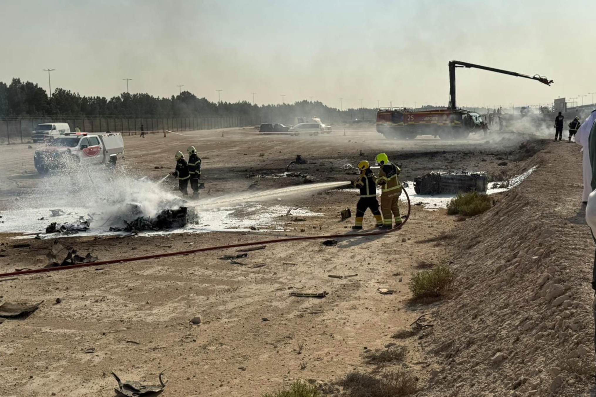 Emergency services attend the scene after an Indian HAL Tejas crashed during a demonstration at the Dubai Air Show, at Al Maktoum International Airport at Dubai World Central, Dubai, United Arab Emirates, Friday Nov. 21, 2025.