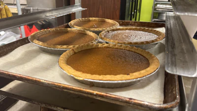 Pies, fresh out of the oven, cool on a baking rack on Friday, Nov. 21, 2025, in Flowood, Miss.