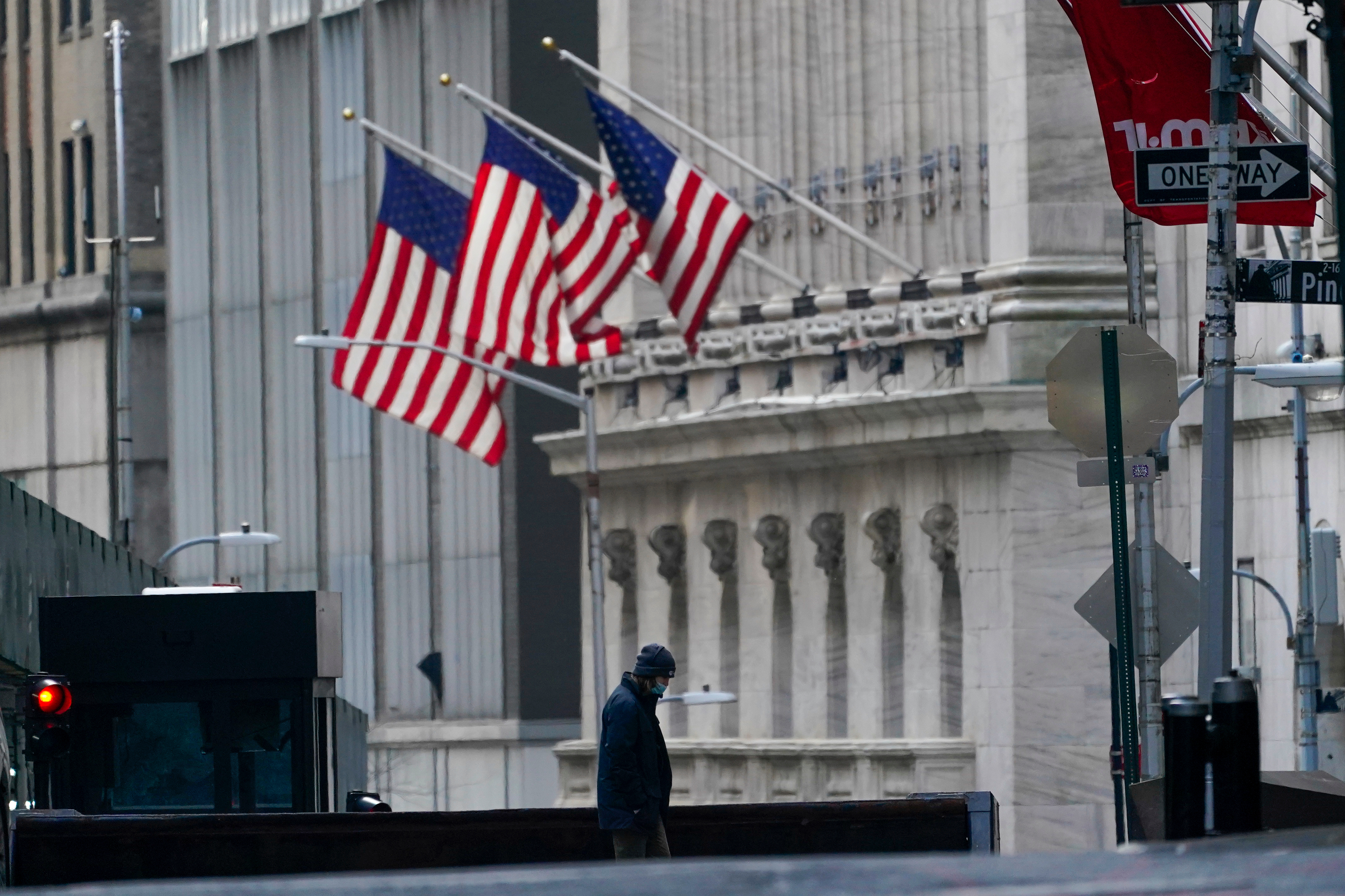 A security guard is seen next to a road block near the New York Stock exchange, Jan. 14, 2022.