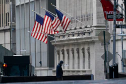 A security guard is seen next to a road block near the New York Stock exchange, Jan. 14, 2022.