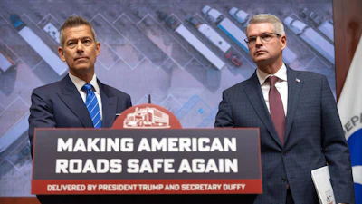 Transportation Secretary Sean Duffy, left, and Derek Barrs, Administrator of the Federal Motor Carrier Safety Administration, listen to a reporter's question during a news conference at the Department of Transportation in Washington, Friday, Dec. 12, 2025.