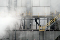 A worker walks through steam coming from the Tyson Foods' beef plant in Lexington, Neb., Thursday, Dec. 4, 2025.