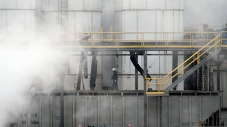 A worker walks through steam coming from the Tyson Foods' beef plant in Lexington, Neb., Thursday, Dec. 4, 2025.