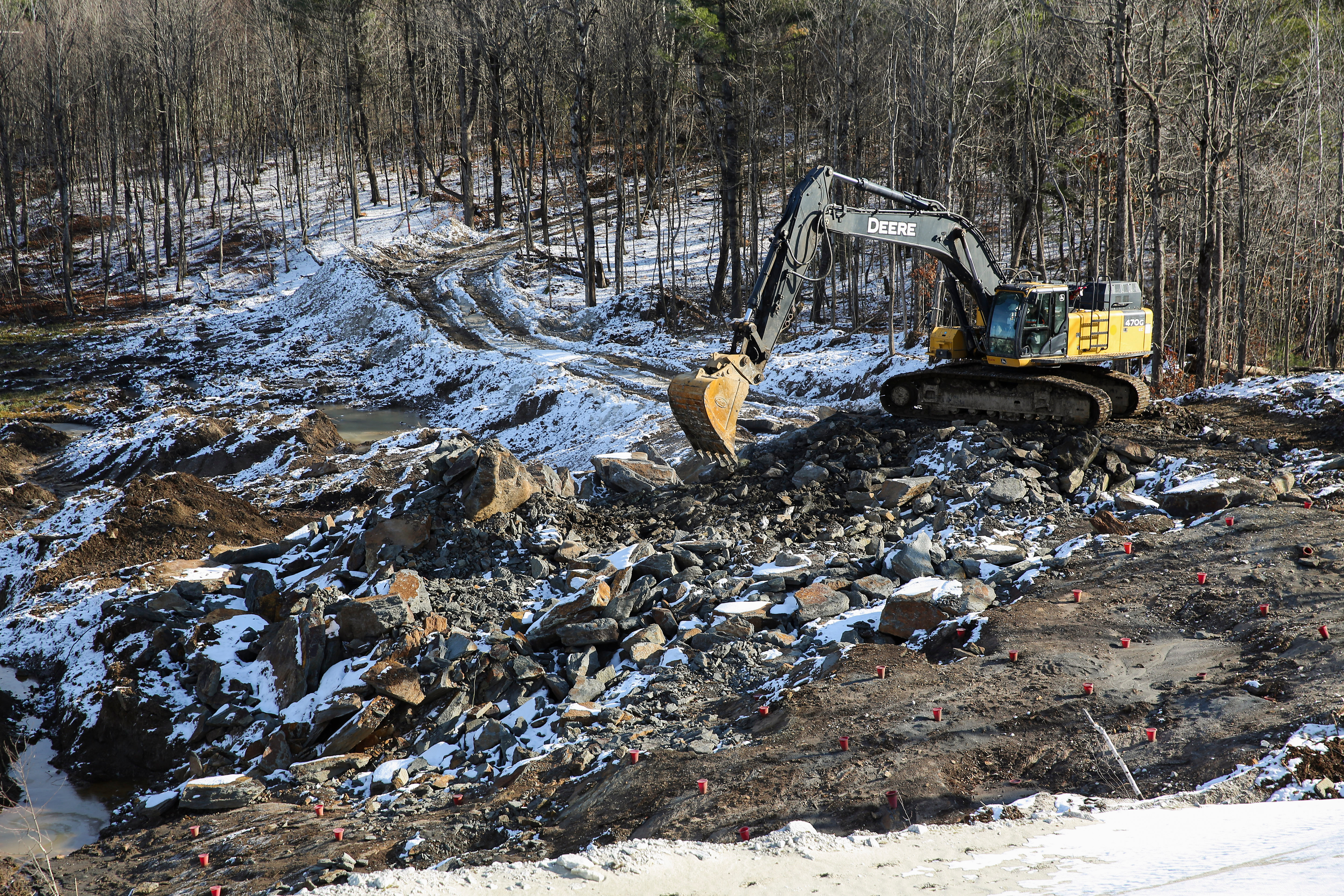 An excavator moves rocks at a graphite mine, Nov. 20, 2025, in Gouverneur, N.Y.