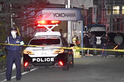 Police officers stand guard at the scene of a stabbing at the Yokohama Rubber Company in Mishima, west of Tokyo, Friday, Dec. 26, 2025.