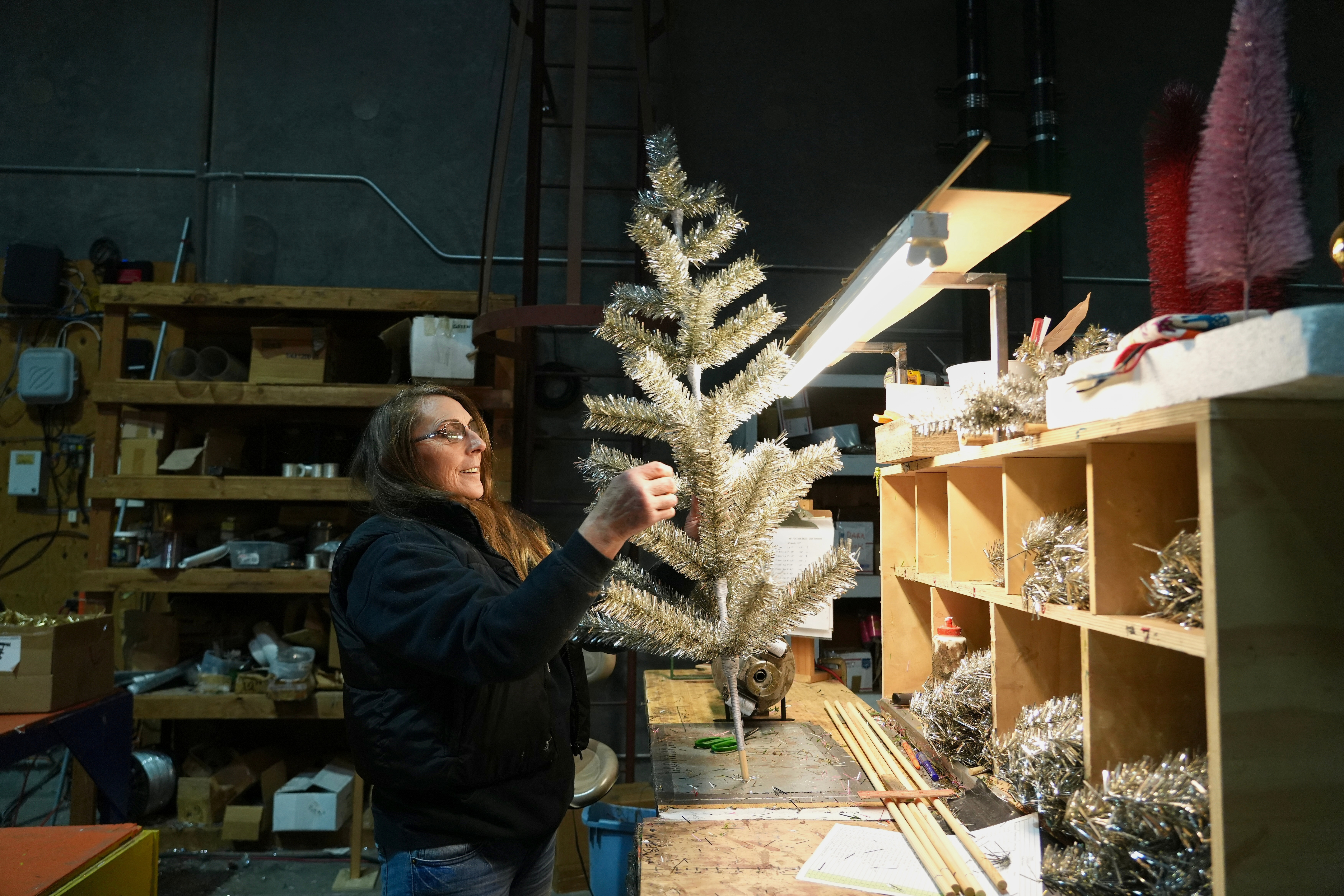 Melissa Webb assembles an artificial Christmas tree at Lee Display's warehouse, in Fairfield, Calif., Tuesday, Dec. 9, 2025.