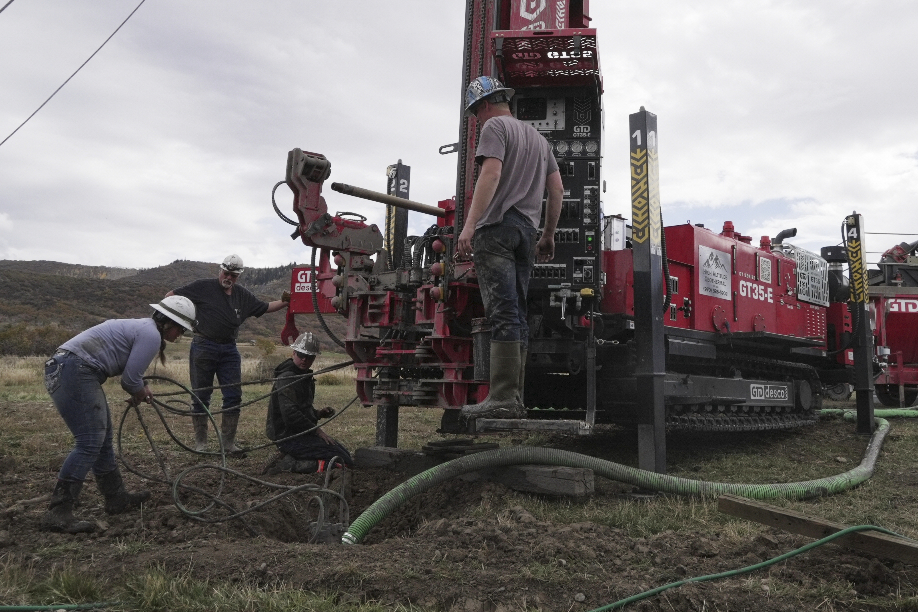 Matt Cooper and his kids Anna, Nathan and Matthew prepare to drill a hole for a geothermal heat pump installation Thursday, Oct. 9, 2025, in Hamilton, Colo.