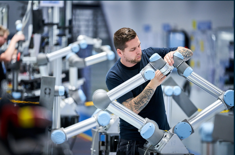 A technician works on a Universal Robots collaborative robot.