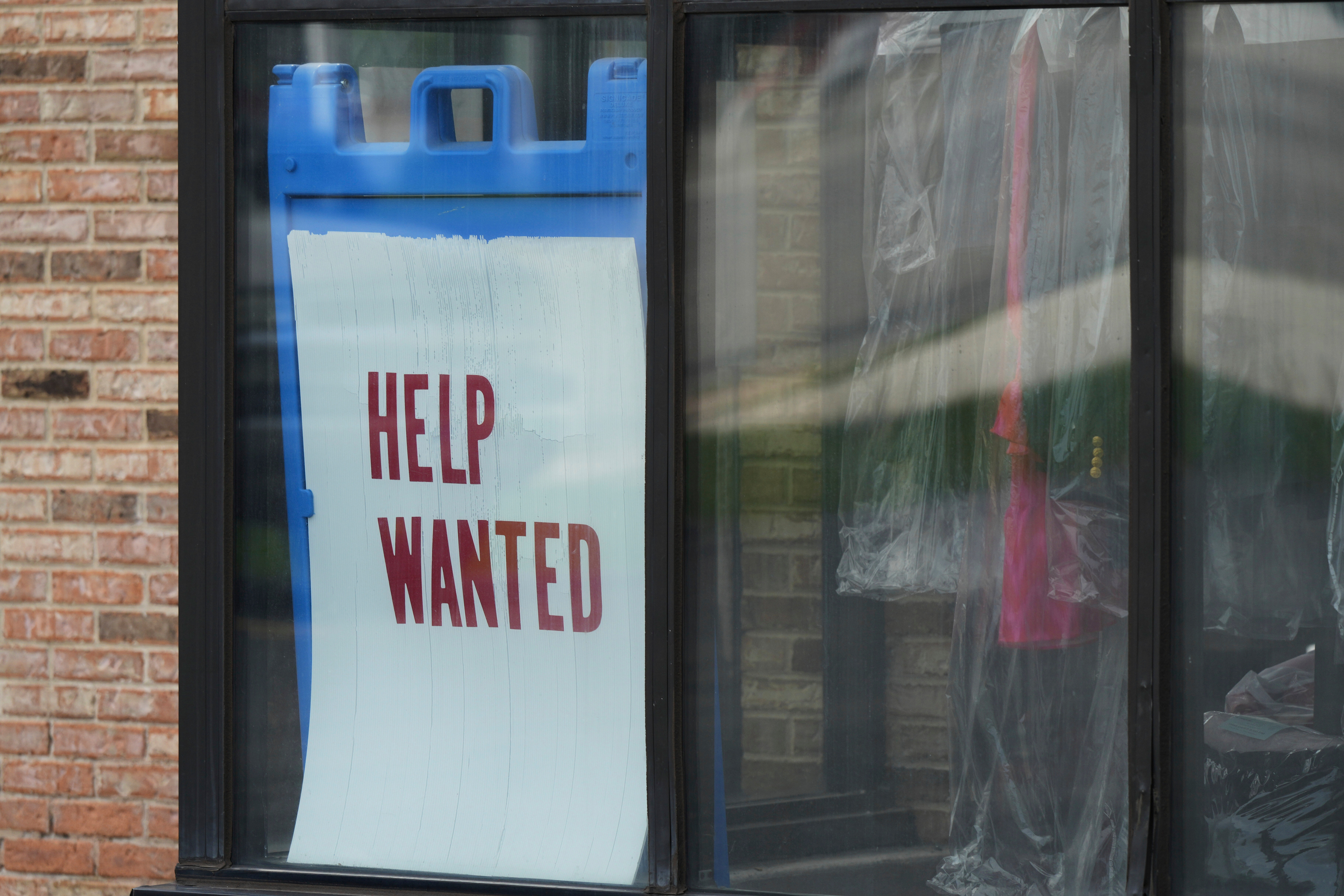 'Help Wanted' sign is displayed at a dry cleaner in Rolling Meadows, Ill., Thursday, May 15, 2025.