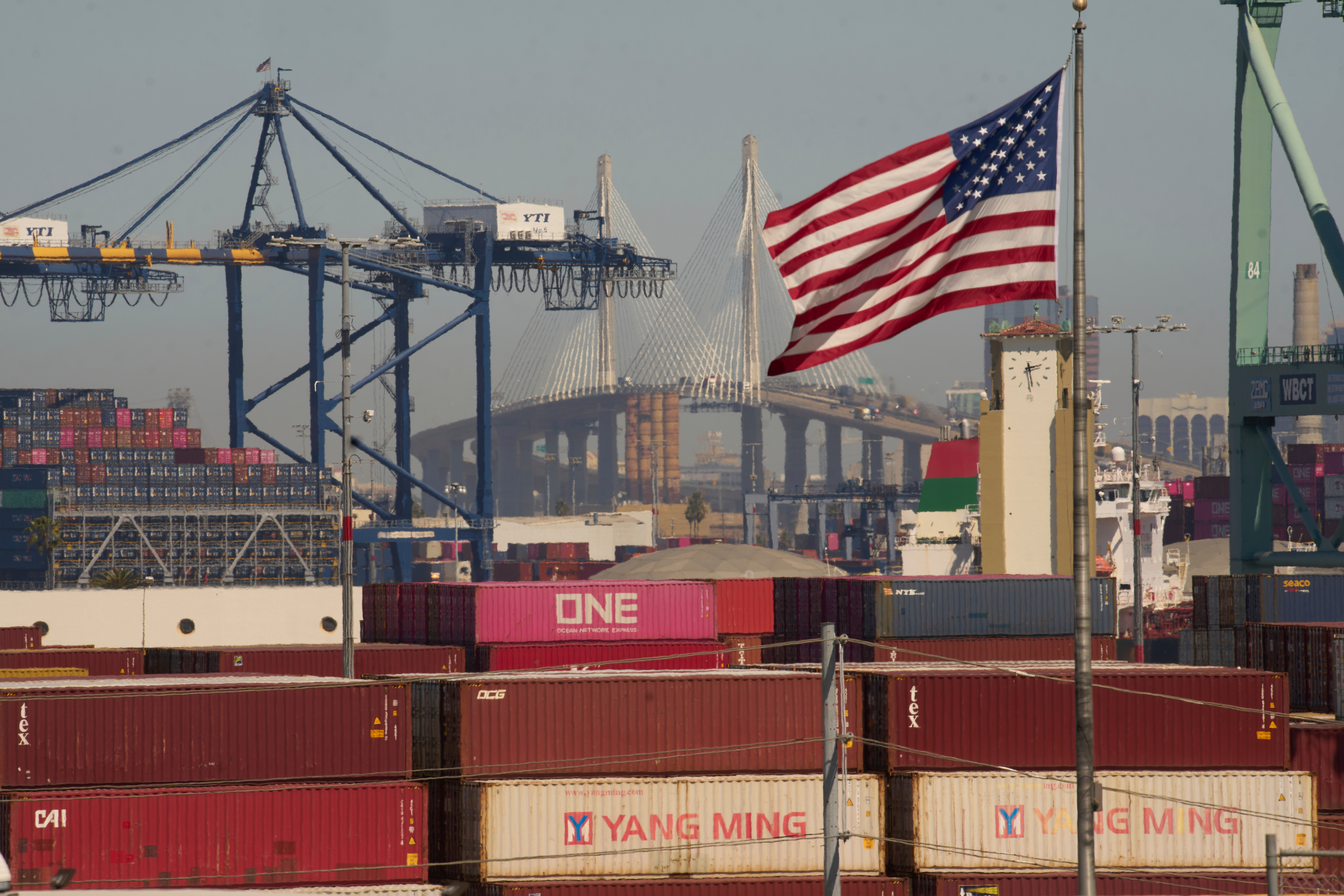 Containers with Yang Ming Marine Transport Corporation, a Taiwanese container shipping company, are stacked up at the Port of Los Angeles with the the Long Beach International Gateway Bridge seen in the background on Wednesday, April 9, 2025 in Los Angeles.