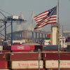 Containers with Yang Ming Marine Transport Corporation, a Taiwanese container shipping company, are stacked up at the Port of Los Angeles with the the Long Beach International Gateway Bridge seen in the background on Wednesday, April 9, 2025 in Los Angeles.