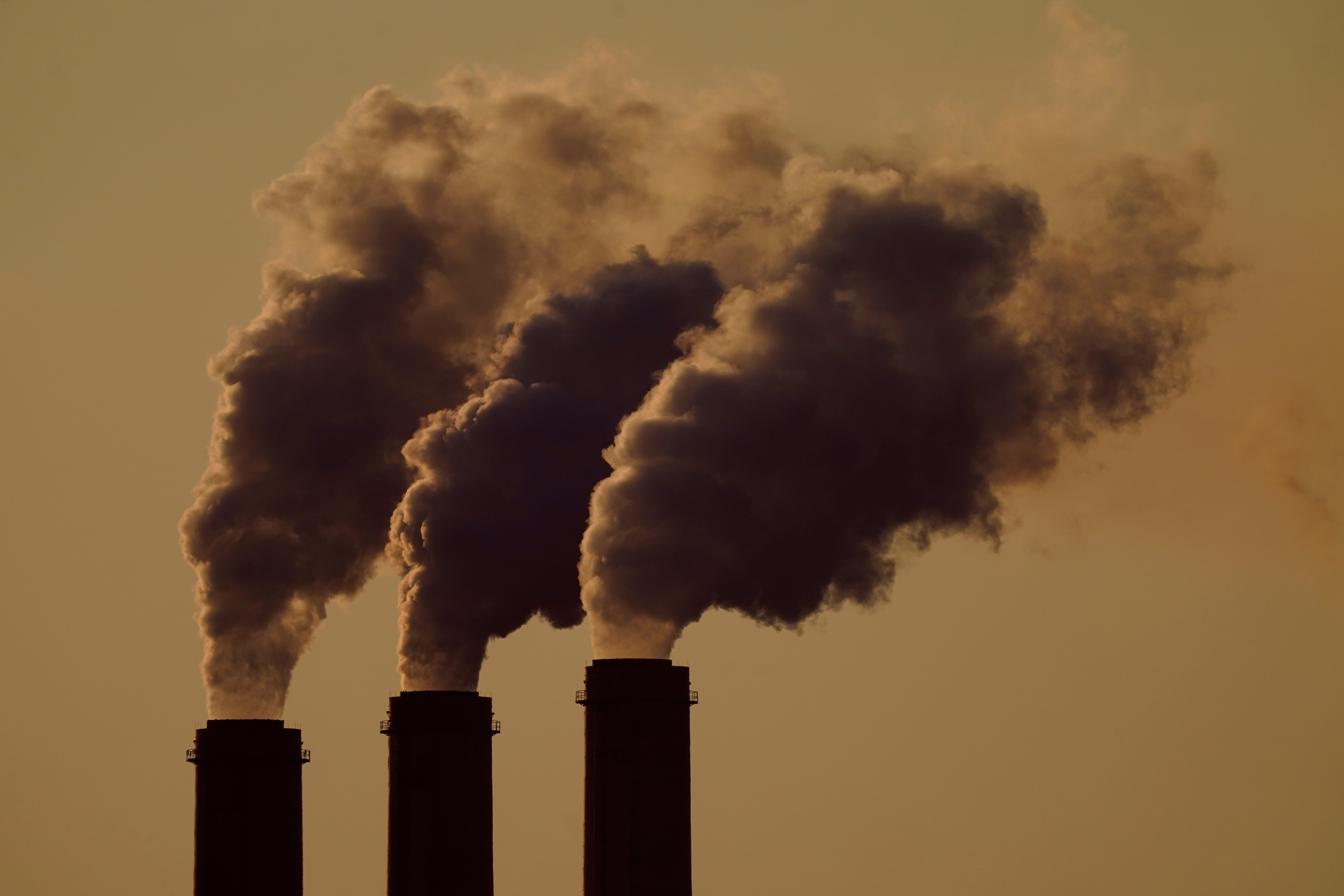 Emissions rise from the smokestacks at the Jeffrey Energy Center coal power plant as the suns sets, near Emmett, Kansas, Sept. 18, 2021.