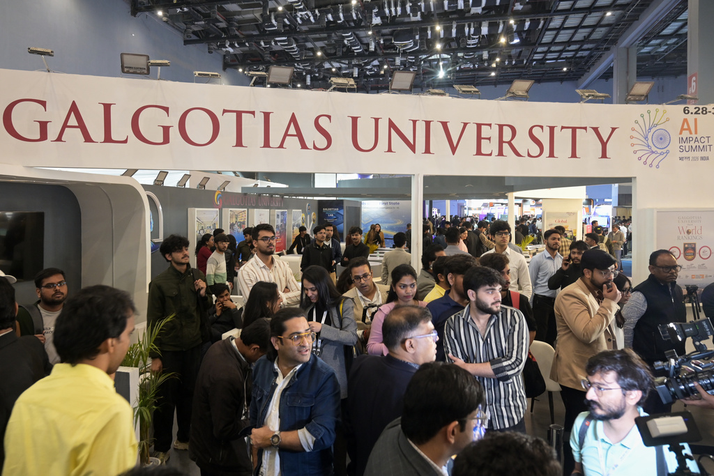 People visit Galgotias University stall at AI summit ahead of an eviction order issued by Indian authorities, in New Delhi, India, Wednesday, Feb. 18, 2026.