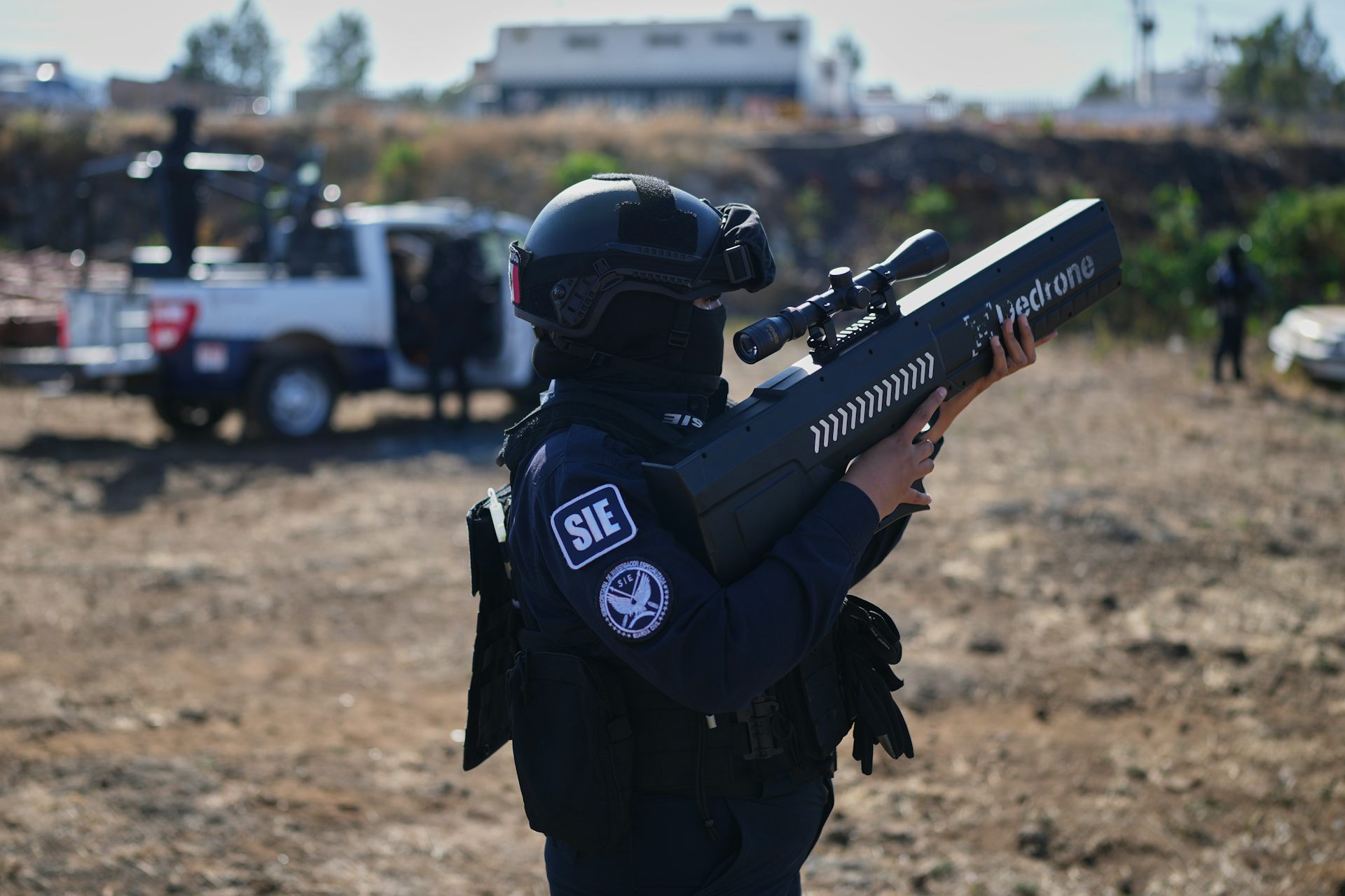 A Mexican law enforcement officer demonstrates a drone jammer.