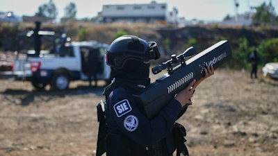 A Mexican law enforcement officer demonstrates a drone jammer.