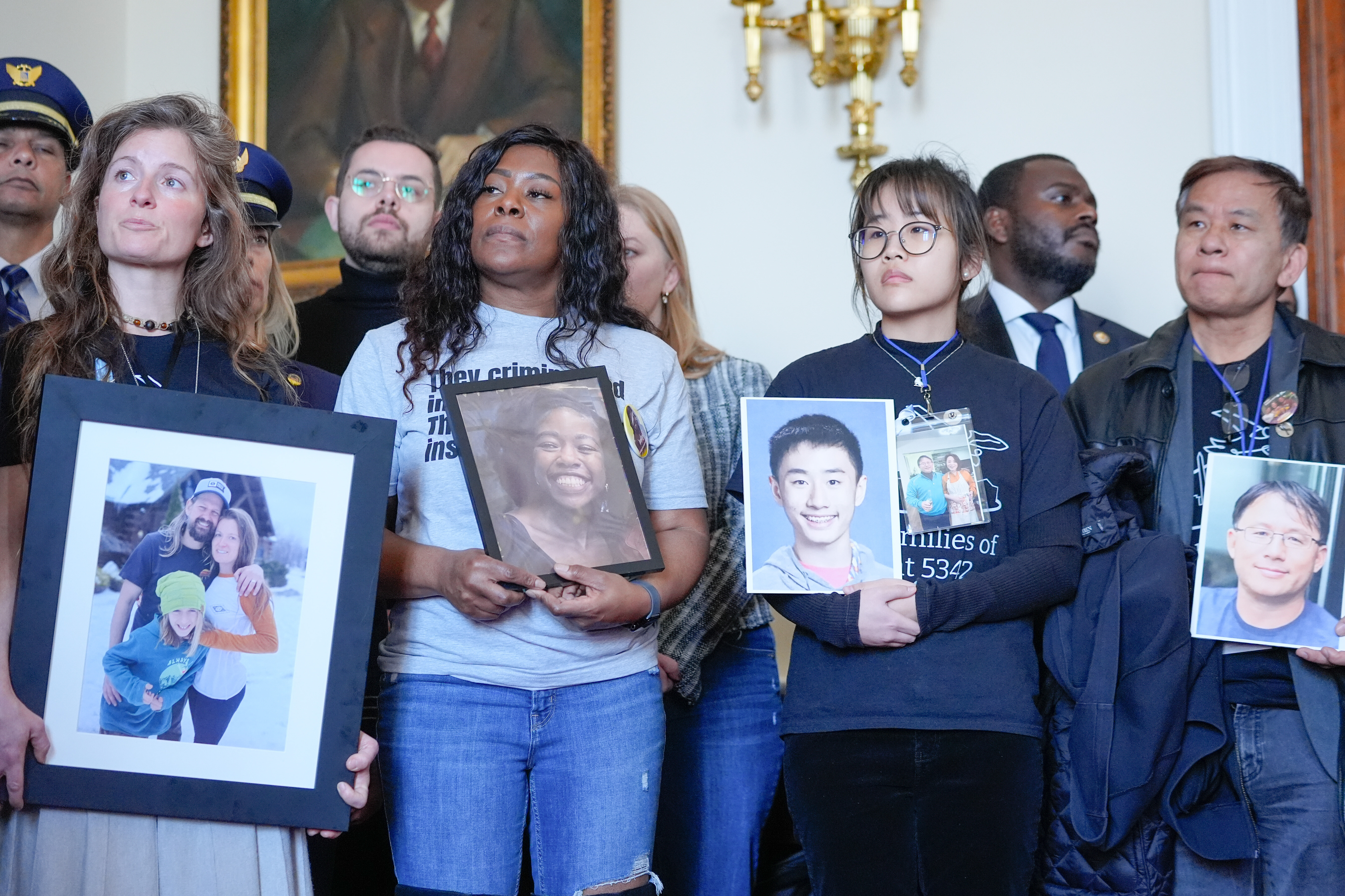 Family members of the people who were killed in the midair collision near Washington Reagan National Airport listen during a news conference as Rep. Don Beyer, D-Va., speaks, not shown, on Capitol Hill, Tuesday, Feb. 24, 2026, in Washington.