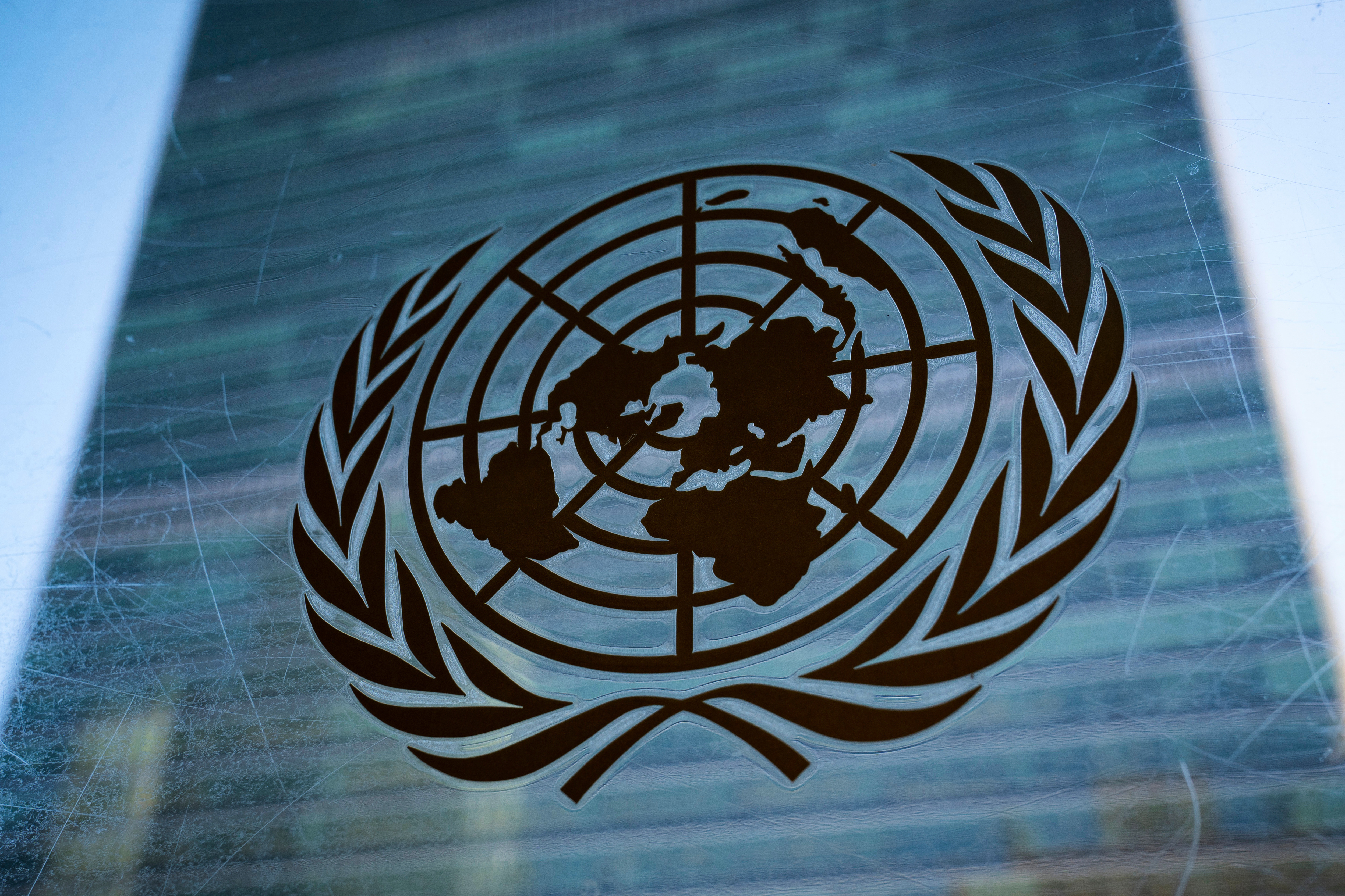 The symbol of the United Nations is displayed outside the Secretariat Building, Feb. 28, 2022, at United Nations Headquarters.