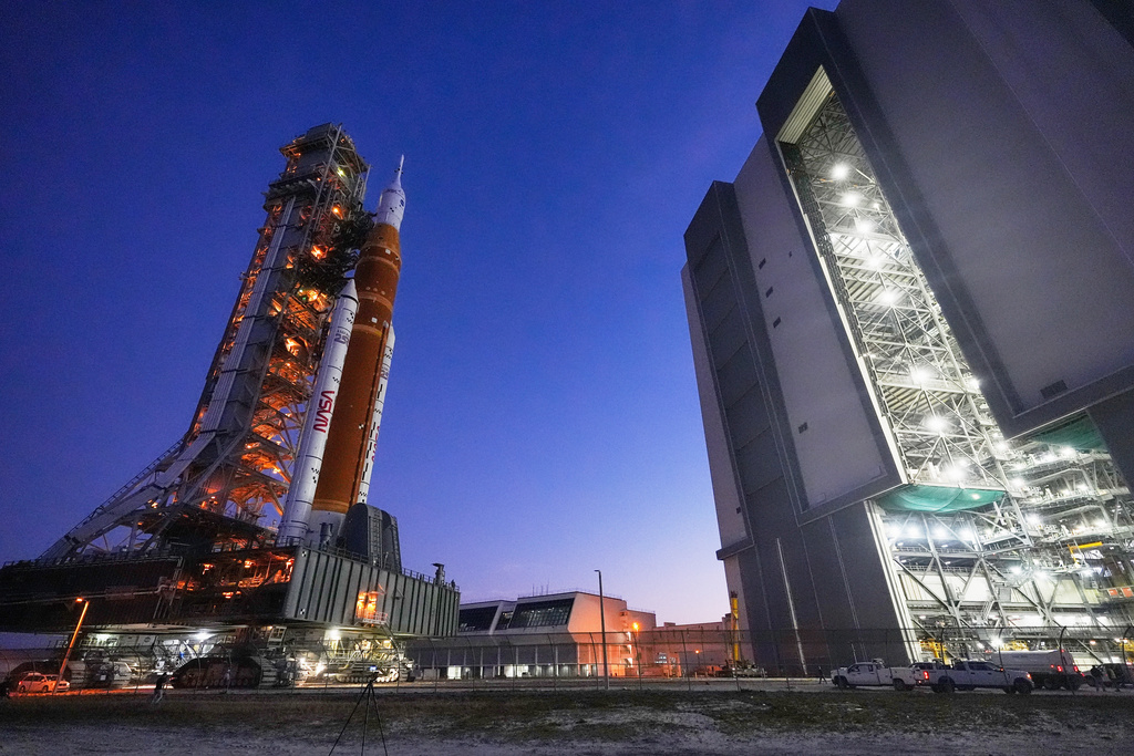 NASA's Artemis II SLS (Space Launch System) moon rocket with the Orion spacecraft slowly rolls back towards the Vehicle Assembly Building at the Kennedy Space Center, Wednesday, Feb. 25, 2026, in Cape Canaveral, Fla.