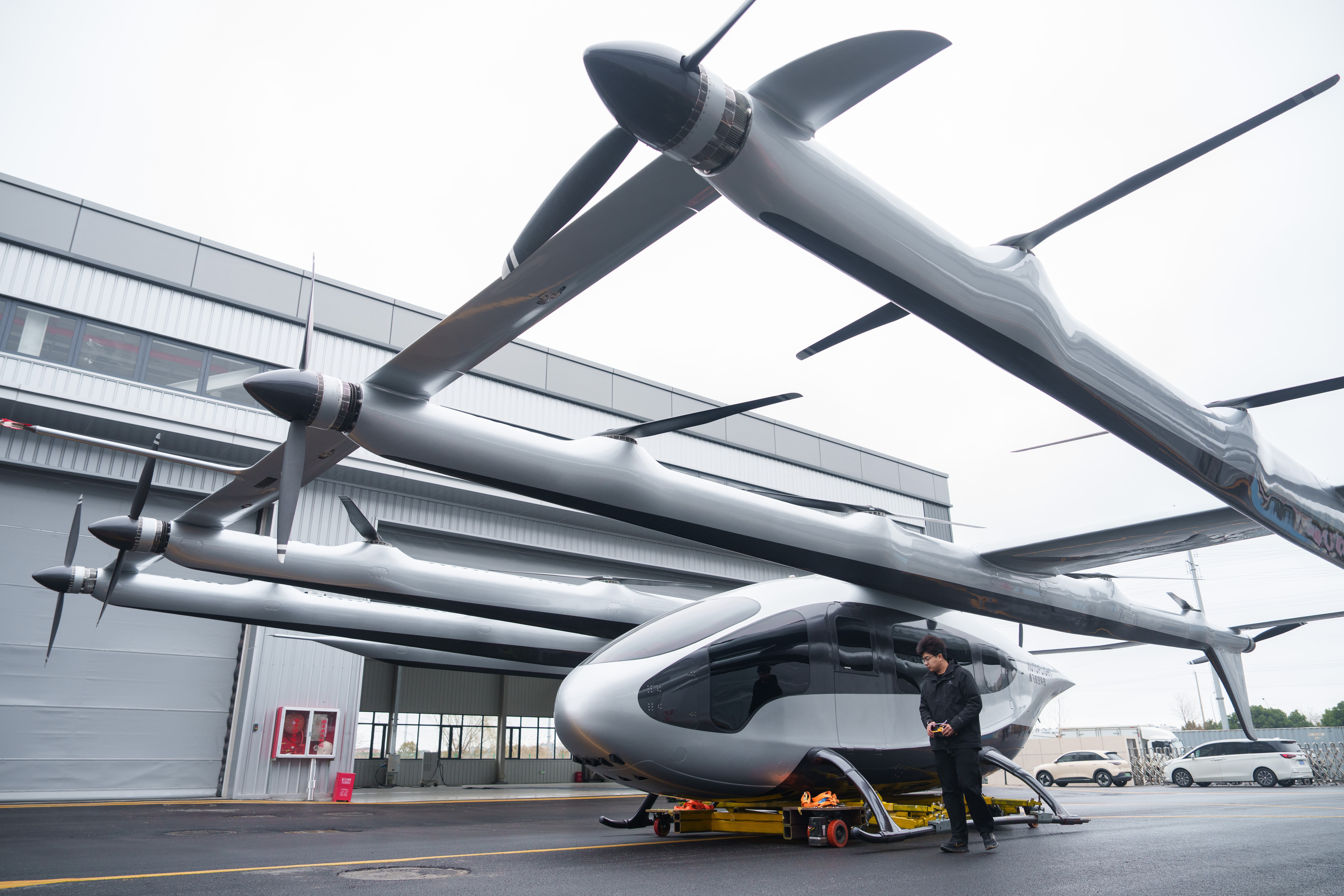 A mechanic moves out a 5-ton class eVTOL aircraft from AutoFlight hanger in Shanghai, China, on Feb. 24, 2026.