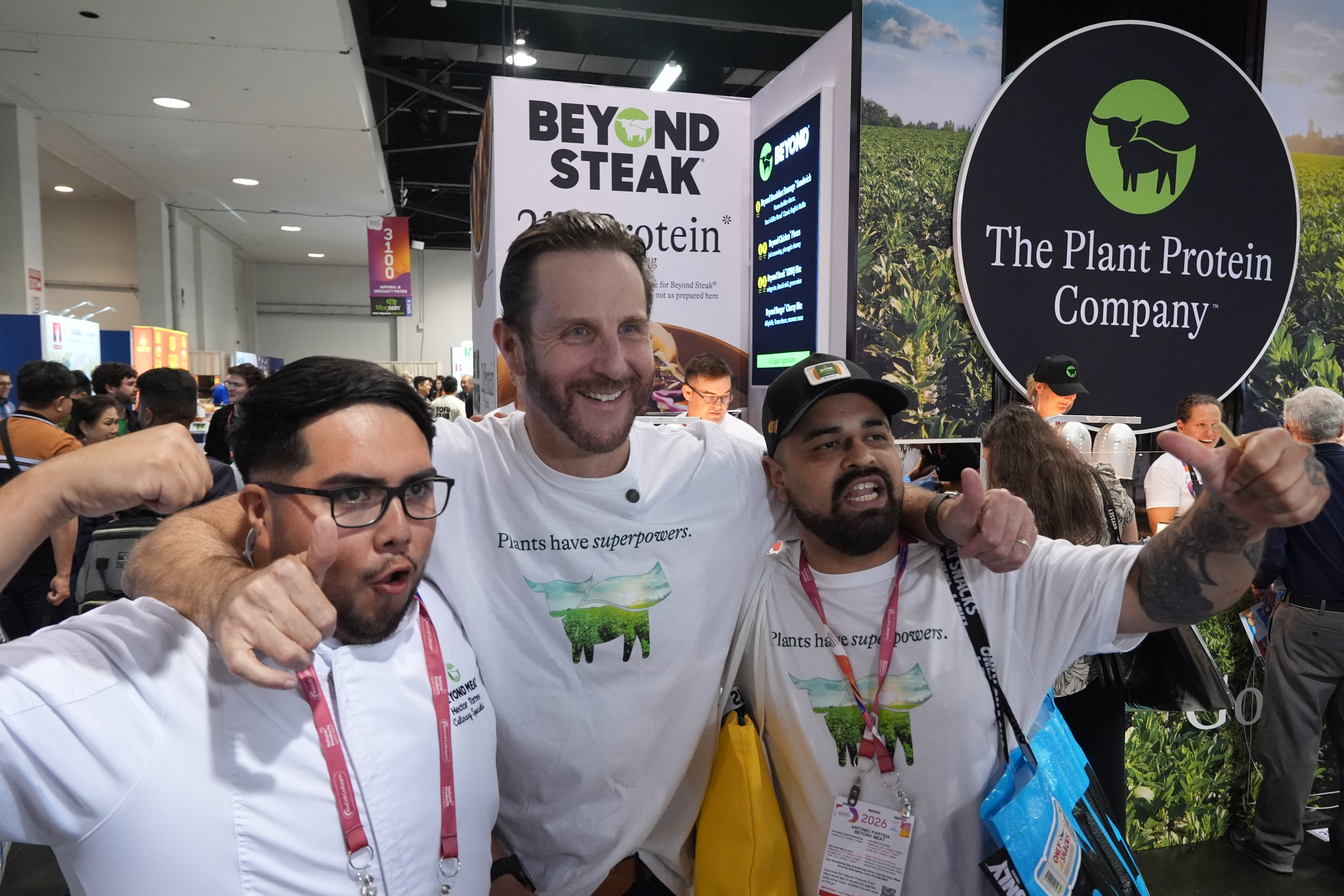 Beyond CEO Ethan Brown, center, with Beyond Meat kitchen assistant Hector Torres, left, and Antonio Partida Sr., kitchen prep, at the Natural Products Expo West, Anaheim, Calif., March 5, 2026.
