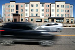 Vehicles pass by the Sapling Grove Apartments, an affordable housing complex, in Aurora, Colo., March 20, 2026.
