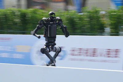 A robot runs as it competes in the Beijing E-Town Half Marathon and Humanoid Robot Half-Marathon on the outskirts of Beijing, Sunday, April 19, 2026.