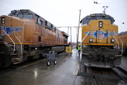 A Union Pacific worker walks between two locomotives in a railyard in Council Bluffs, Iowa, Dec. 15, 2023.