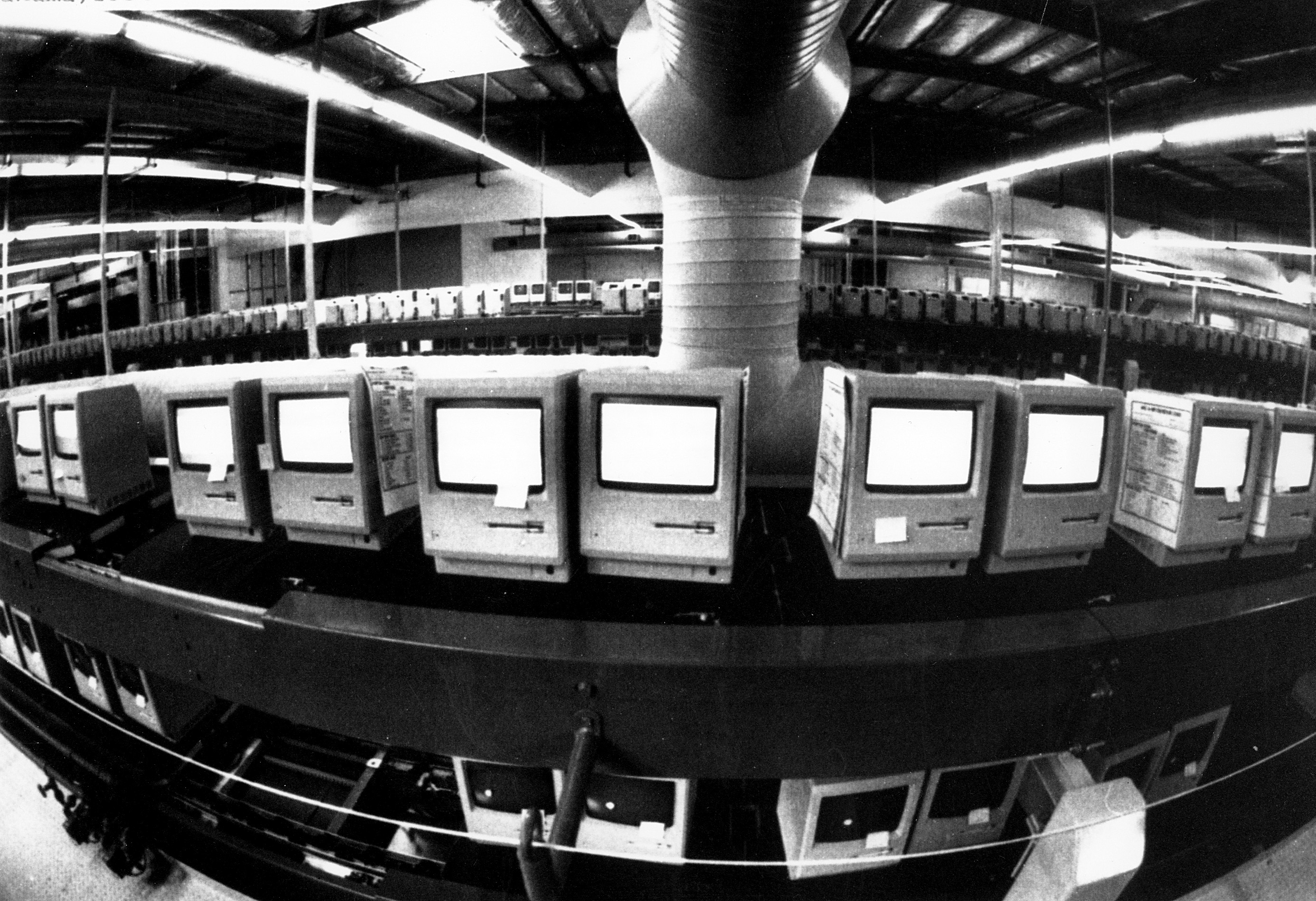 In this March 28, 1984, file photo, thousands of Apple Macintosh computers sit on double decked manufacturing lines.