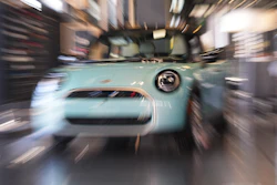 Made with a slow shutter speed and zoom lens, an unsold 2026 Cooper S hardtop is diplayed in a Mini dealership Friday, Oct. 24, 2025, in Highlands Ranch, Colo.