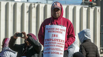 Workers from the JBS Beef Plant protest across the road from the plant on March 16, 2026 in Greeley, Colo.