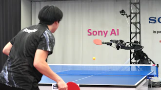 A table tennis robot built by Sony maneuvers to hit the ball back to its human opponent, Akito Saeki, during a match in Tokyo, Dec. 2025.