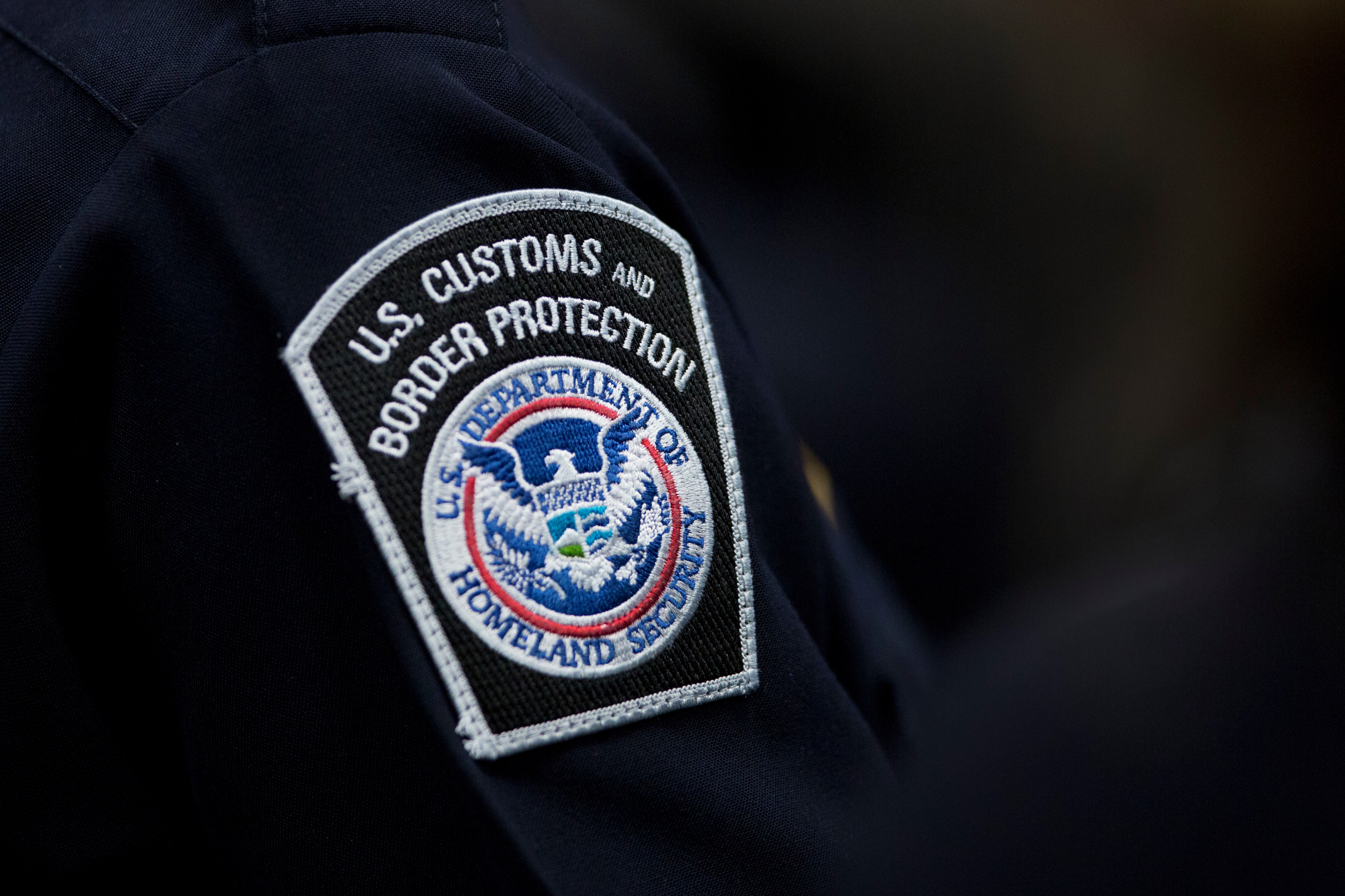 A customs agent wears a patch for the U.S. Customs and Border Protection agency, Oct. 27, 2017, at John F. Kennedy International Airport in New York.