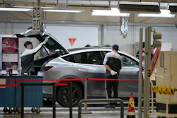 Workers check on the Tesla Model Y at the production lines at the Tesla Gigafactory assembly plant during a media organized tour, in Shanghai, China, Tuesday, April 14, 2026.