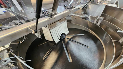 Commercial tilting skillet with stainless steel construction and cooking utensils in professional kitchen
