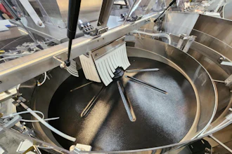 Commercial tilting skillet with stainless steel construction and cooking utensils in professional kitchen