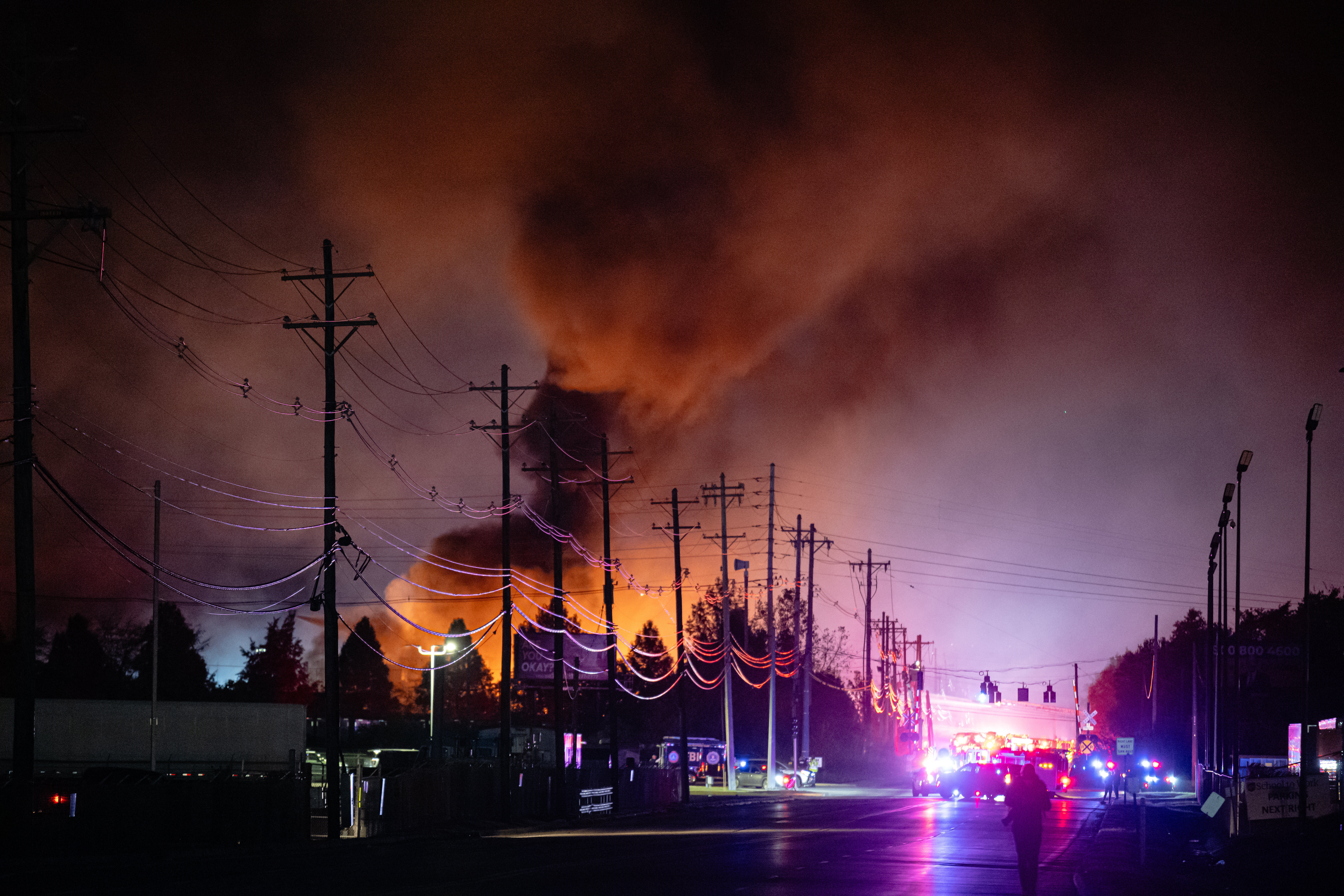 Plumes of smoke rise from the area of a UPS cargo plane crash at Louisville Muhammad Ali International Airport, Nov. 4, 2025, in Louisville, Ky.