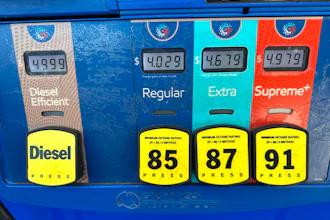 The per-gallon price is displayed electronically above the grades of gasoline available from a pump at an Exxon gasoline station in Litttleton, Colo., Tuesday, May 12, 2026.