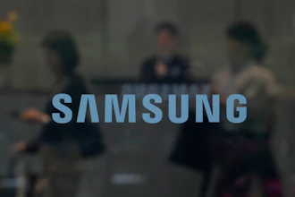 Samsung logo displayed over a blurred corporate meeting scene with business professionals