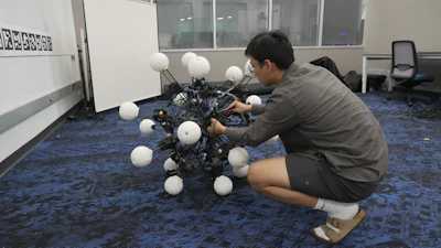 Jiaxun Liu, a Ph.D. student, works on a robot named Argus at Duke University's General Robotics Lab in Durham, N.C., Tuesday, May 26, 2026.