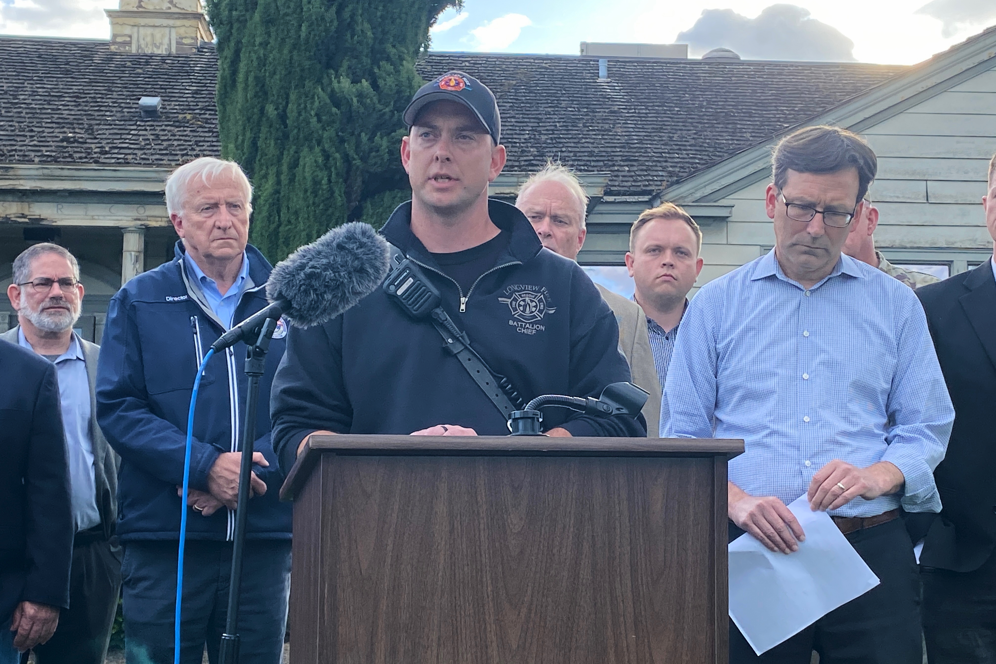 Longview Fire Department Battalion Chief Matt Amos speaks at a press conference in Longview, Wash., Tuesday, May 26, 2026, at the site of a paper mill where a chemical tank failure killed at least one person and left others unaccounted for.